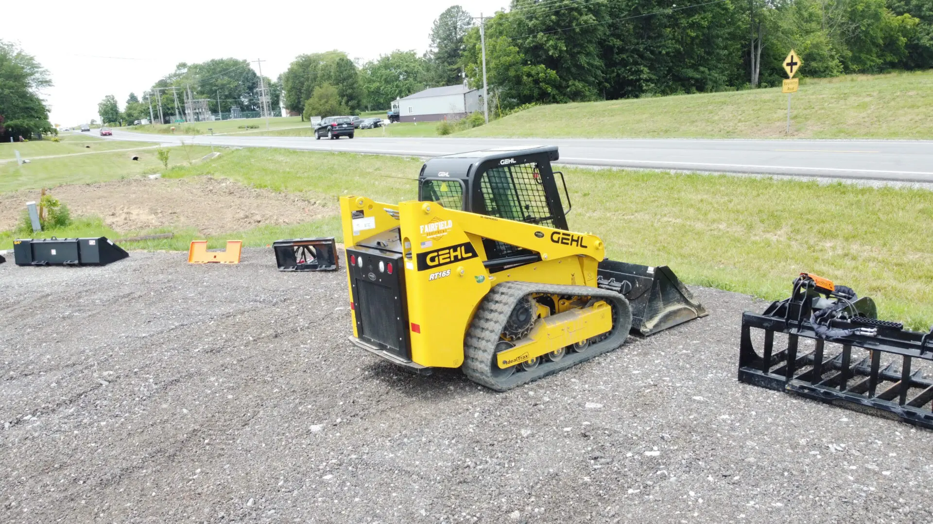 Yellow Gehl skid steer on gravel.