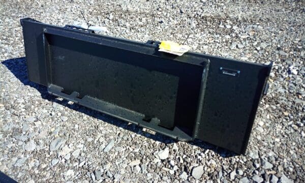 Black metal skid steer attachment.