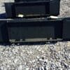 Black metal skid steer bucket attachment.