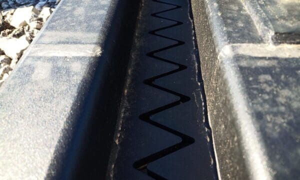 Close up of a zig-zag pattern on black rubber.