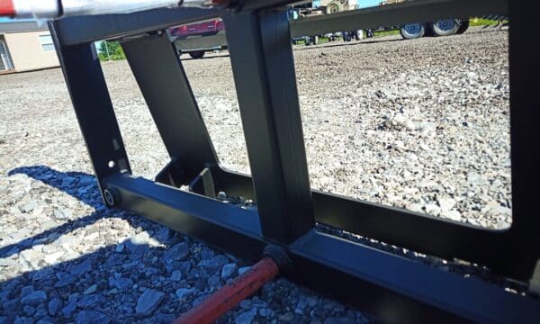 Black metal frame on gravel ground.