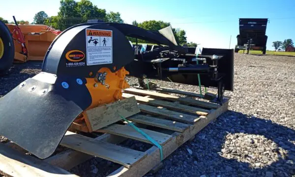 Black and yellow stump grinder on pallet.