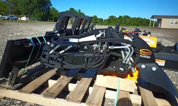 Black hydraulic excavator attachment on pallet.