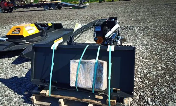 Black and yellow brush cutter on pallet.