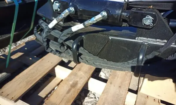 Black hydraulic hoses on a pallet.