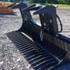 Black rock rake attachment for tractor.