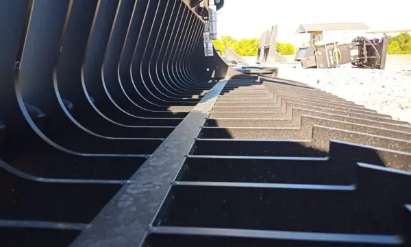 Close-up of a black excavator bucket.