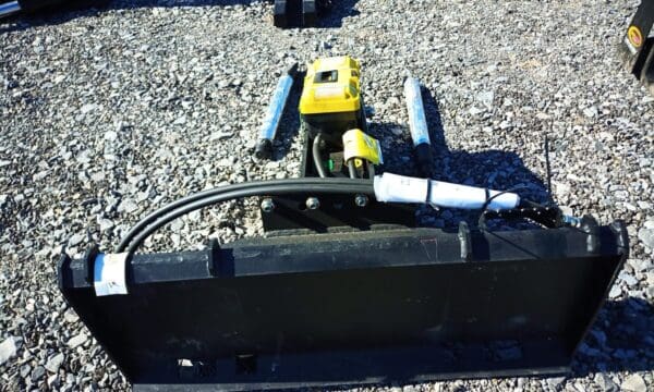 Black hydraulic excavator attachment with hoses.