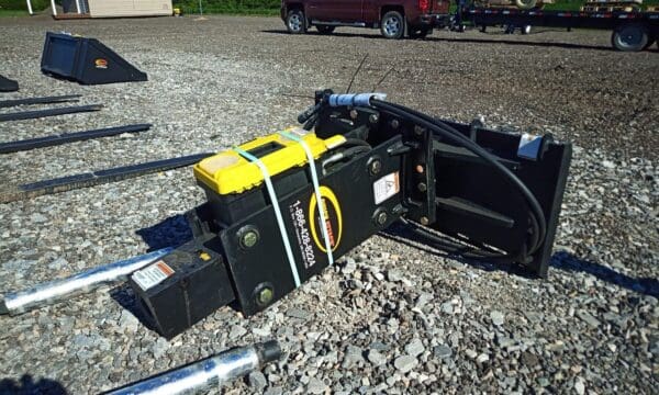 Black hydraulic breaker with yellow label.