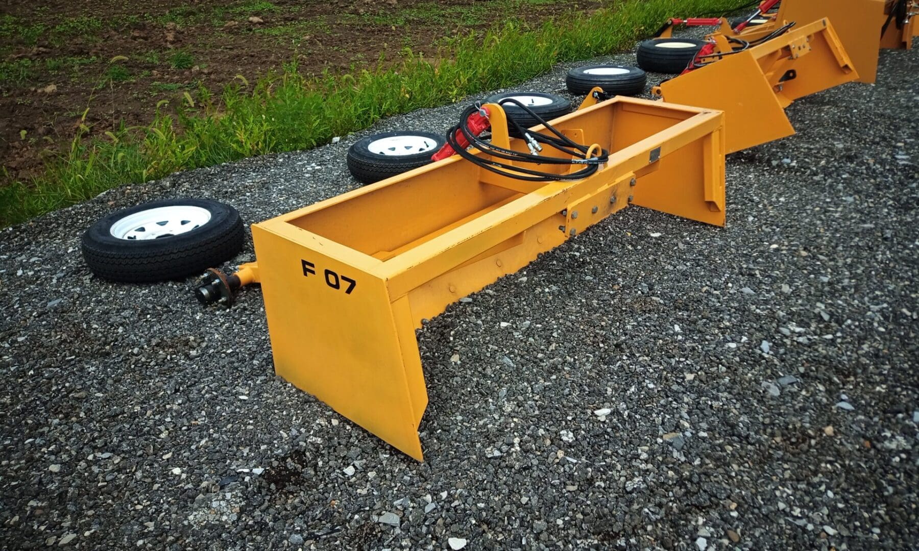 Yellow F07 box scraper on gravel.