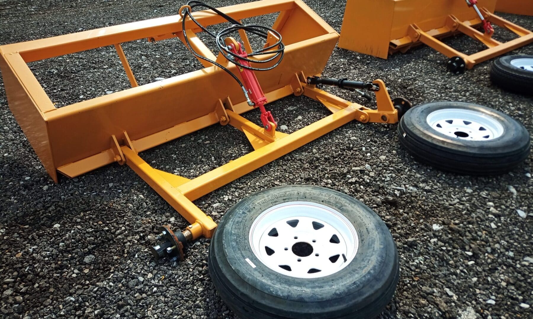 Yellow farm equipment with three wheels.