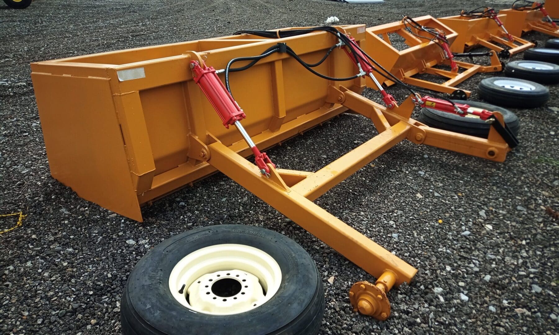 Yellow farm equipment with large wheels.