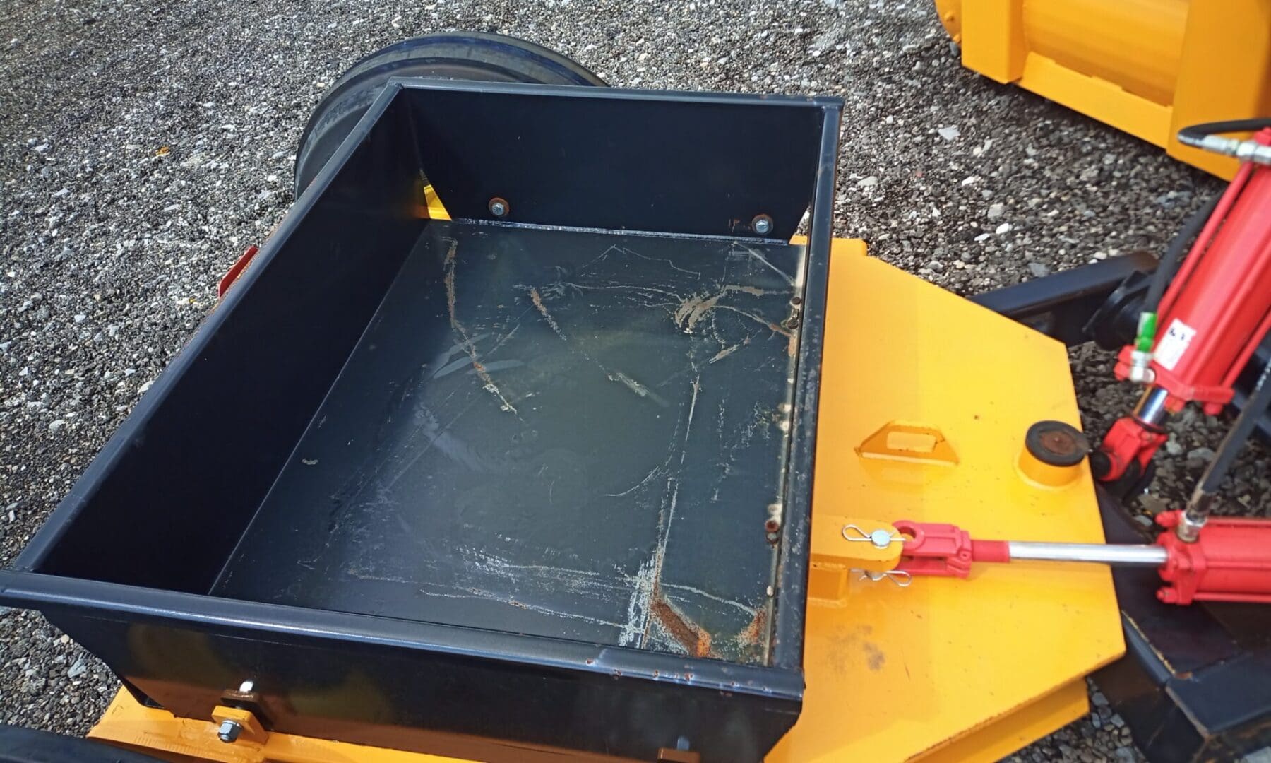 Empty metal trailer bed with hydraulics.