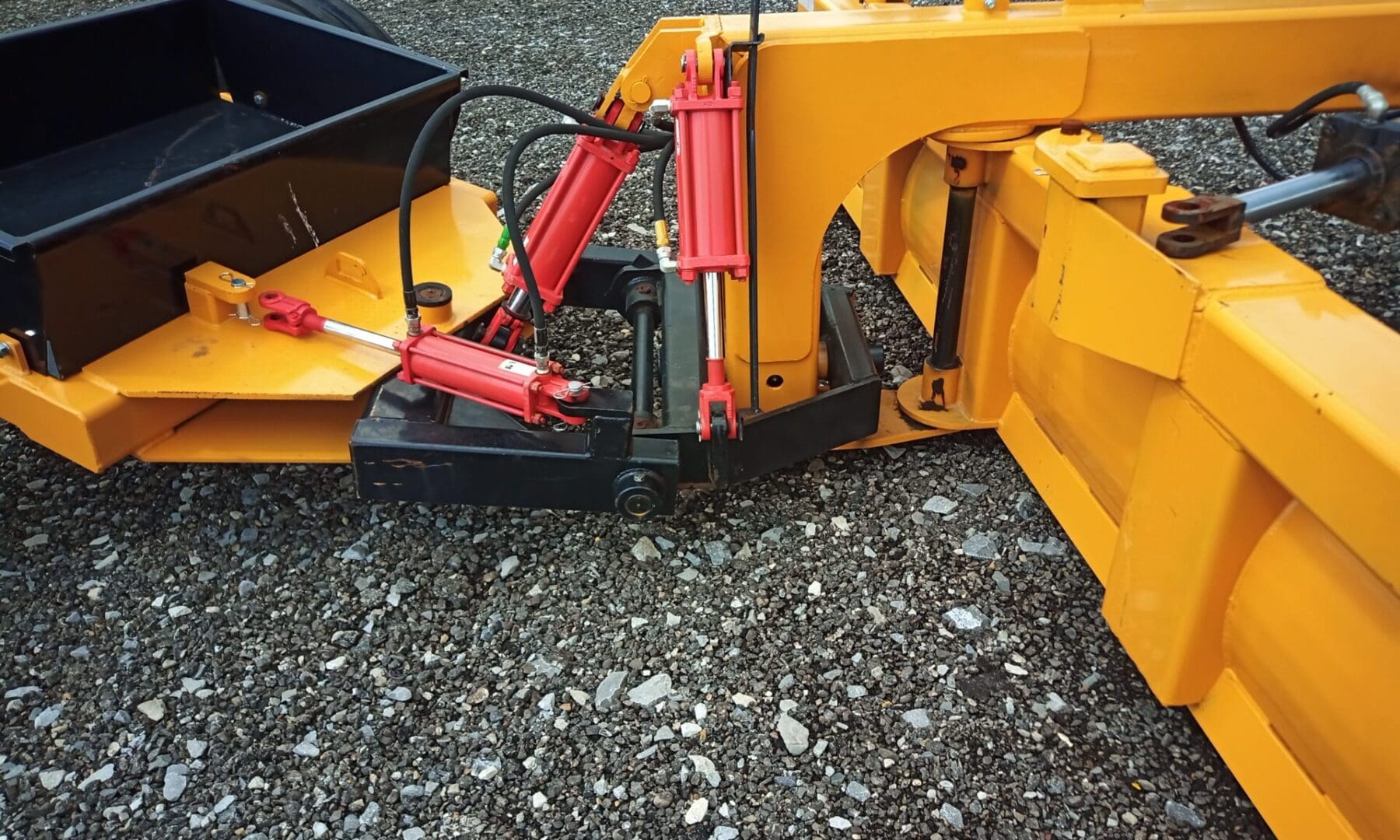 Yellow hydraulics of a tractor attachment.