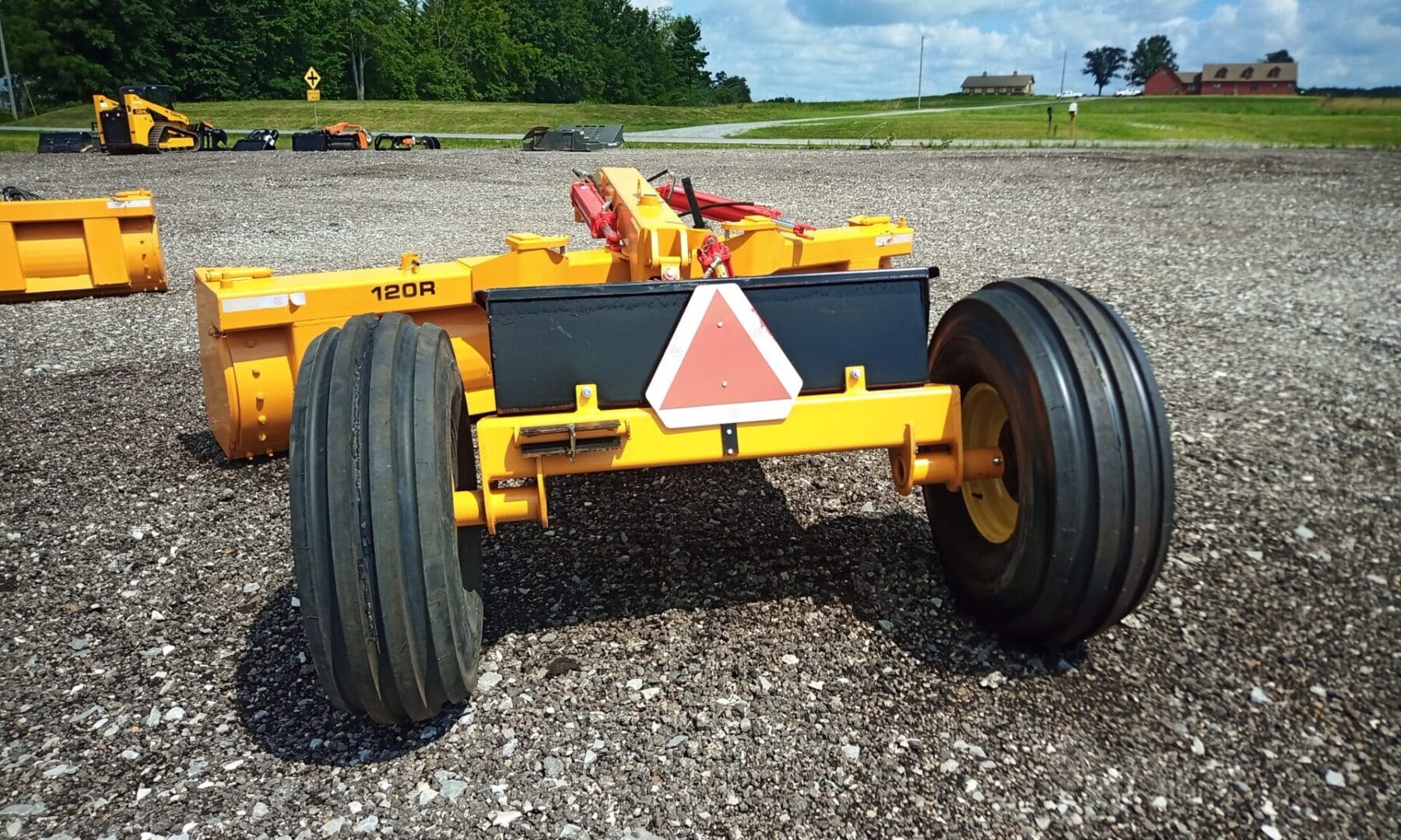 Yellow farm equipment with large tires.