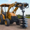 Orange tractor with post hole digger.