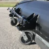 Close-up of runway sweeper wheels and spray bar.
