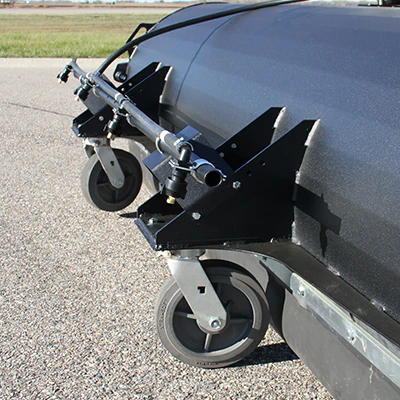 Close-up of runway sweeper wheels and spray bar.