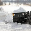 Snow plow removing snow in winter.
