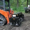 Skid steer with land leveler attachment.