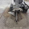 Here's an alt tag for the image: Concrete cutting machine at work.