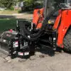 Skid steer with asphalt milling attachment.