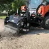 Skidsteer pavement planer removing asphalt.