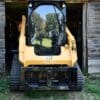 Yellow CAT skid steer in barn.