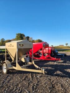 Tan and red bulk feed trailers.