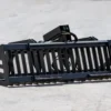 Here's a short alt tag for the image: Black heavy-duty landscape rake attachment.
