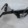 Here's a short alt tag for the image: `Hydraulic tree stump grinder attachment`