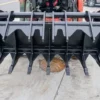 Here's an alt tag for the image: Black heavy-duty grapple attachment.