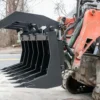 Here's an alt tag for the image: `Black grapple bucket attached to excavator`